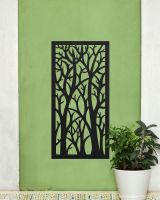 "Black Autumnal Trees Garden Wall Screen" mounted on a green wall next to a plant 