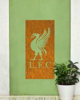 Rustic "Liver Bird Wall Art" mounted on a green wall next to a potted plant 