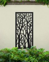"Black Autumnal Trees Garden Wall Screen" mounted on a garden all amongst plants