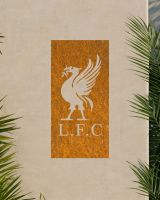 Rustic "Liver Bird Wall Art" on a beige garden wall surrounded by palm leaves 