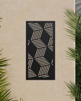 Black "Geometric Cube Wall Art" mounted on a beige garden wall surrounded by palm leaves Black "Geometric Cube Wall Art" mounted on a beige garden wall surrounded by palm leaves