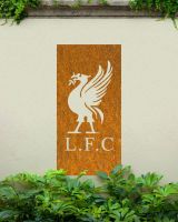 Rustic "Liver Bird Wall Art" on a cream garden wall behind garden plants