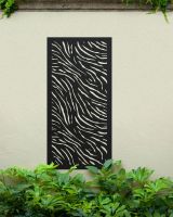 Stylish "Black Zebra Print Garden Wall Art" on a cream wall amongst garden plants Stylish "Black Zebra Print Garden Wall Art" on a cream wall amongst garden plants