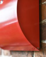 Close-Up of Curved Design on Wall-Mounted Post Box