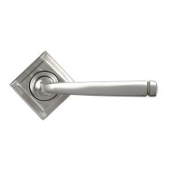The Valen Tapered Sprung Handle Set on a Square Rose in Satin Stainless Steel Shown with the Square Backplate in a Diamond Orientation