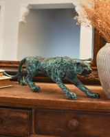 Three quarter view of verdigris leopard sculpture