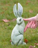 Verdant Watchers Pair of Sitting Rabbit Garden Sculpture Cast Aluminium - ears up sculpture on their own with hand in shot for scale Verdant Watchers Pair of Sitting Rabbit Garden Sculpture Cast Aluminium - ears up sculpture on their own with hand in shot for scale