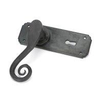 Ververt Beeswax Monkeytail Lever Handle Set with Key Hole Shown on its side on a White Background 