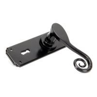 Ververt Black Monkey Tail Lever Handle Set With Key Hole laying on its Side on a White Background Ververt Black Monkey Tail Lever Handle Set With Key Hole laying on its Side on a White Background