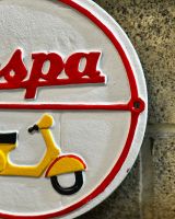 Close up of hand painted detail on cast iron wall sign