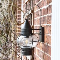 Side View of the Vintage Round Caged Wall Lantern Mounted on a Brick Wall