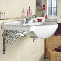 Bright Chrome Serpent Shelf Bracket shown on sink