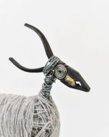 Close up of intricate face detail on recycled metal art sculpture