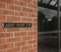 The "Warrington’ Modern Brass House Sign