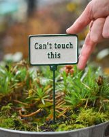 Witty Cast Iron Plant Pot Spike “Can’t Touch This” with hand to reference scale