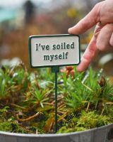 Witty Cast Iron Plant Pot Spike “I’ve Soiled Myself” with hand for scale reference