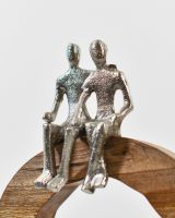 Close up of silver cast aluminium figures on home decor art sculpture Close up of silver cast aluminium figures on home decor art sculpture
