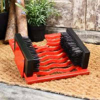 Bright red cast iron three in one boot jack, brush & scraper