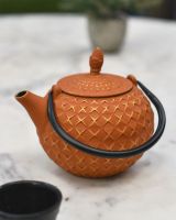 Side view of "Xinbei" Cast Iron Orange Japanese Style Teapot Side view of "Xinbei" Cast Iron Orange Japanese Style Teapot