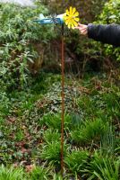 Vintage Airplane Wind Spinner Stakes in Blue and Yellow with Hand in Shot for Scale