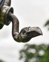Close up of intricate face detail on recycled metal vulture sculpture