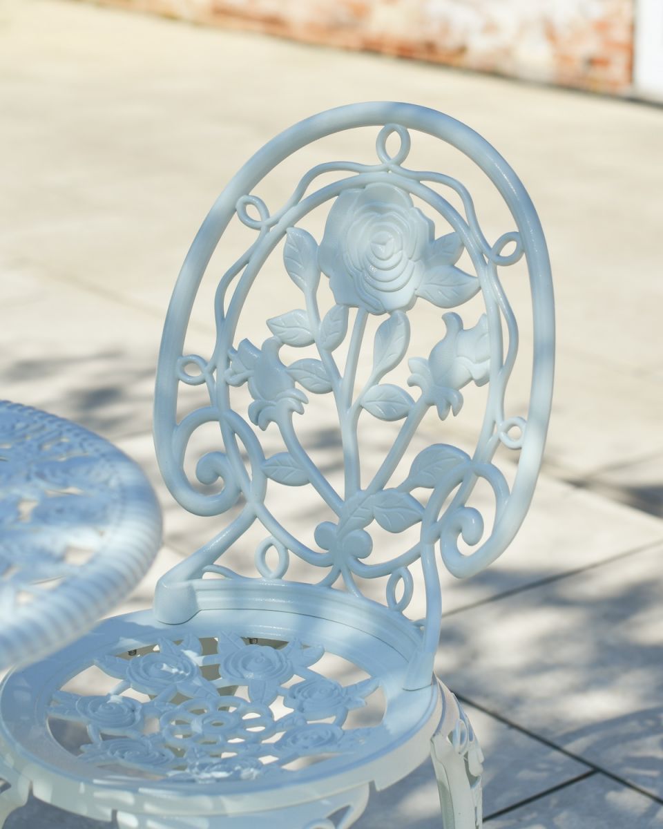 Close up of floral detailing on chair backrest on outdoor two seater furniture set