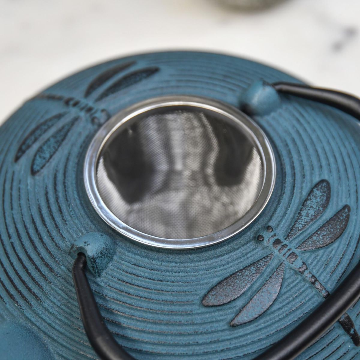 Close-Up of Tea Infuser on Blue "Dragonfly" Cast Iron Teapot