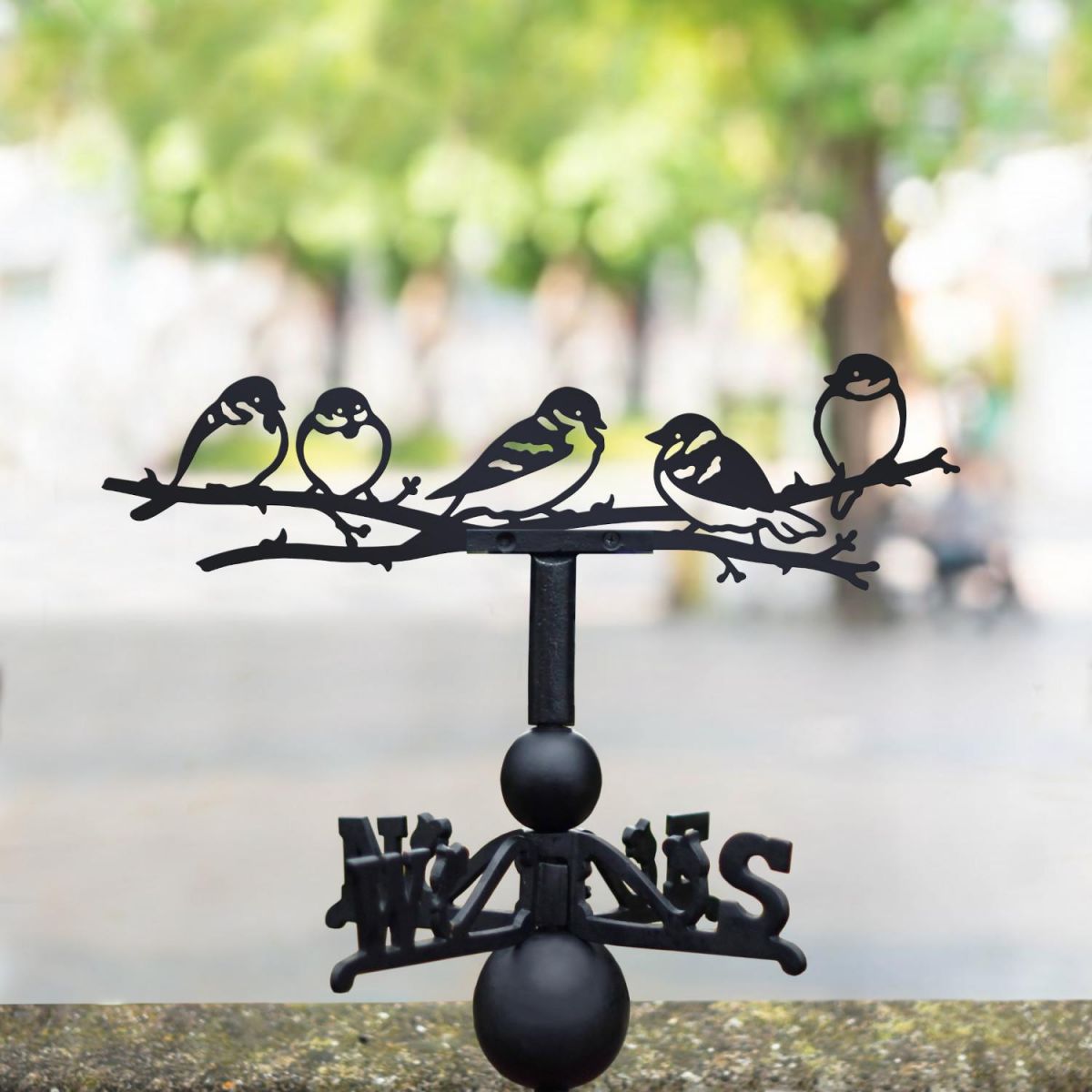 Group of sparrows weathervane in the park