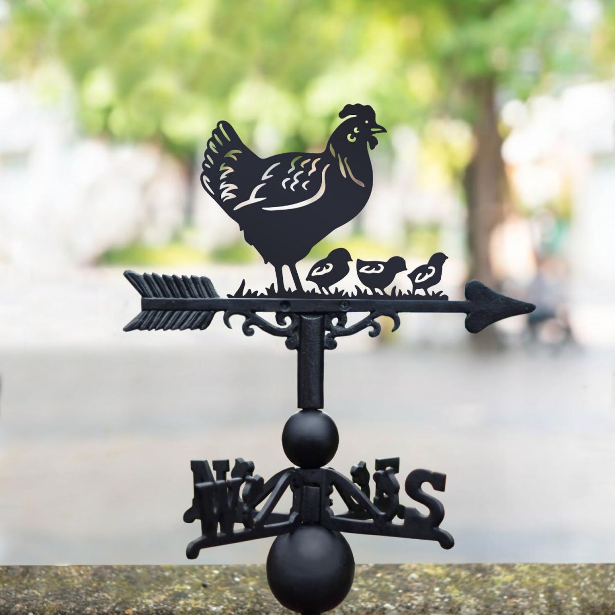 Hen & three chicks weathervane in the park