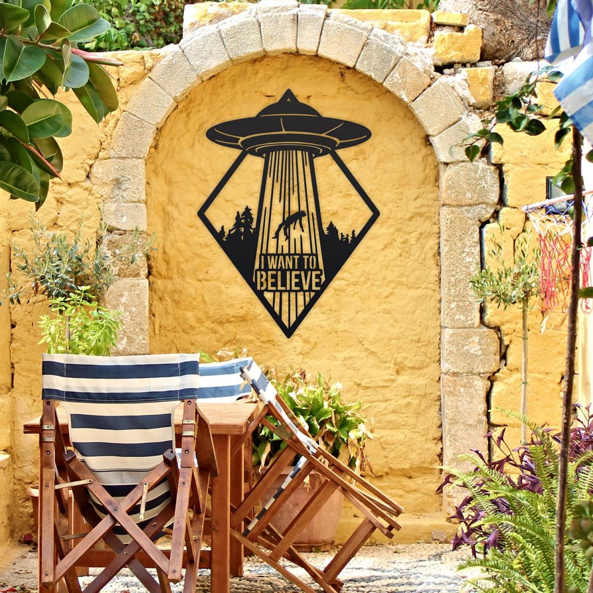 "I Want to Believe" Alien Wall Art on a Yellow Brick Wall