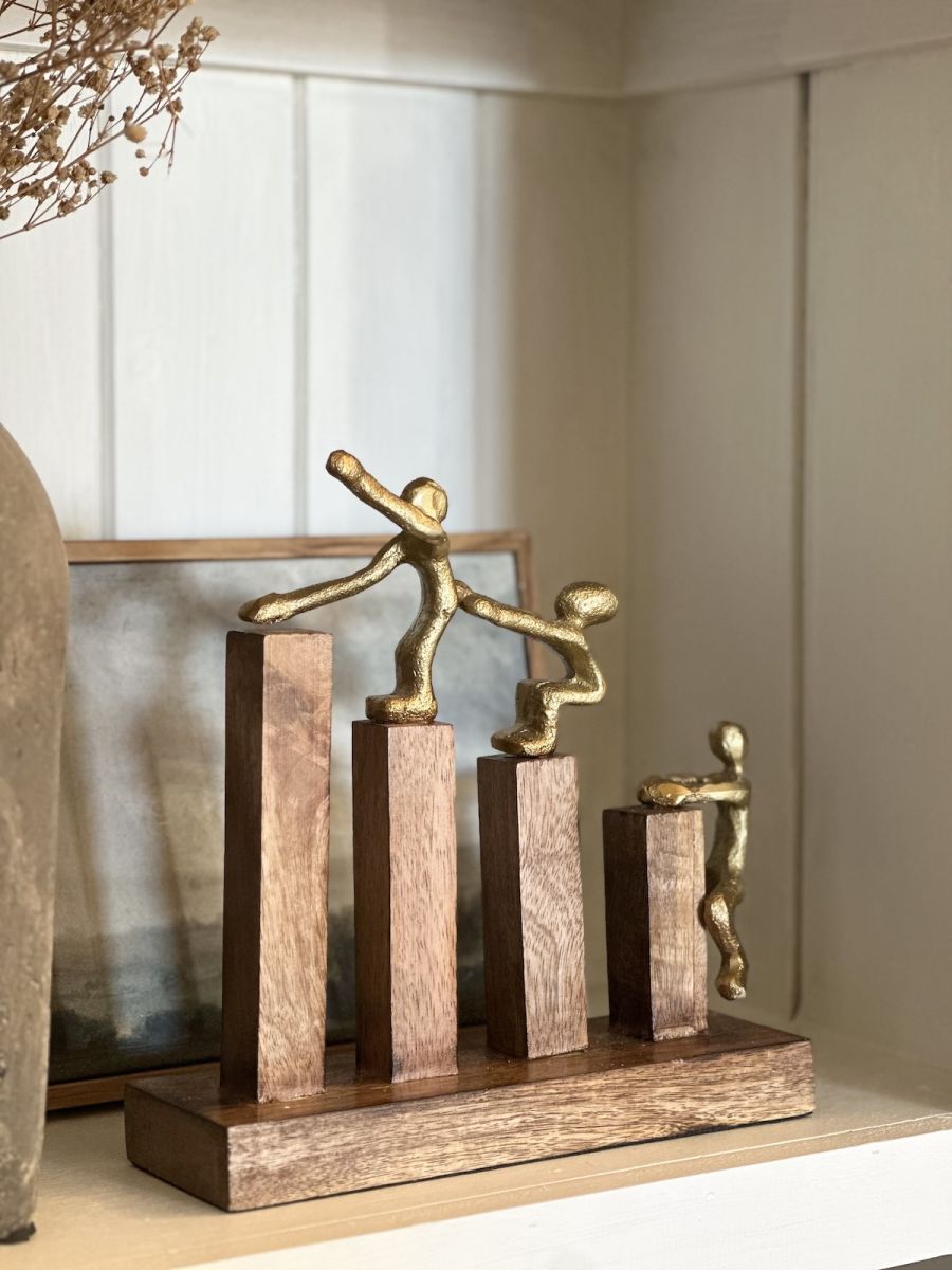 Angled view of gold figure home decor accessory