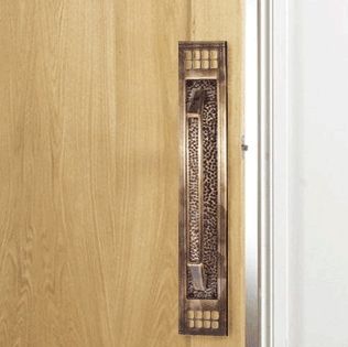 Large Antique Brass Door Pull Handle in Situ on Wooden Door
