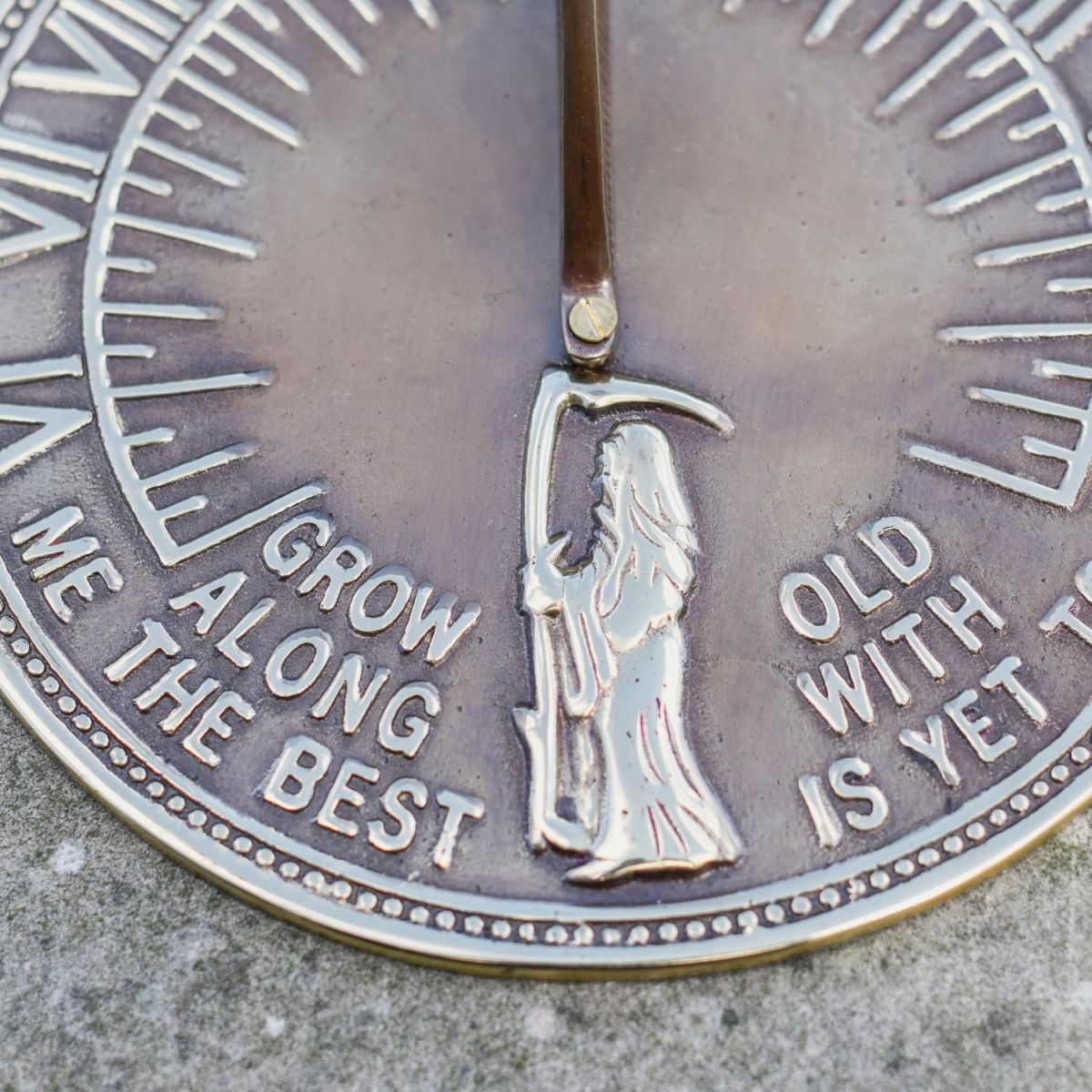 Close-Up of Old Father Time Designed Sundial in Antique Brass