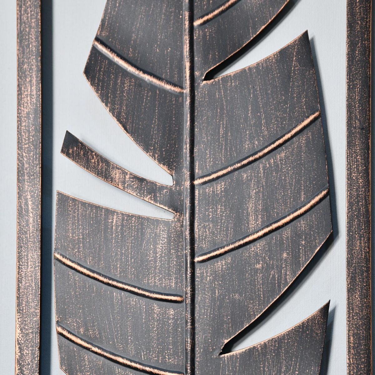 Close-up of the Antique Bronze Feather Wall Art in Frame
