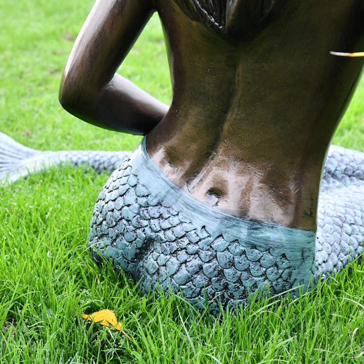View of the Back of the Antique Bronze Mermaid Garden Sculpture