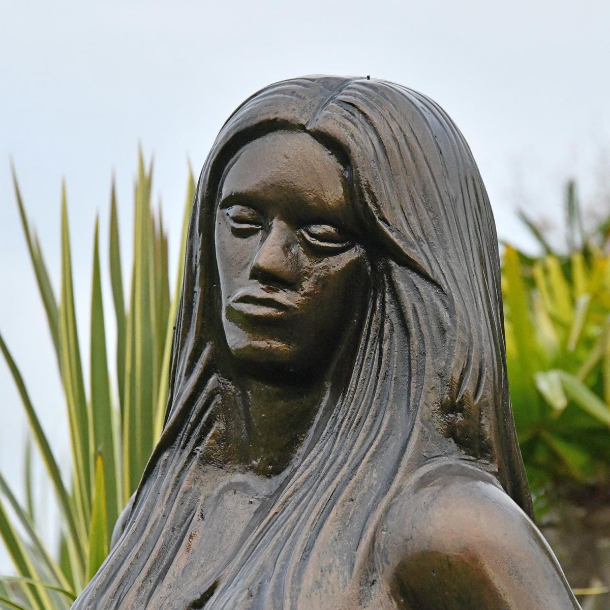 Close-up of the Antique Bronze Face on the Mermaid Garden Sculpture