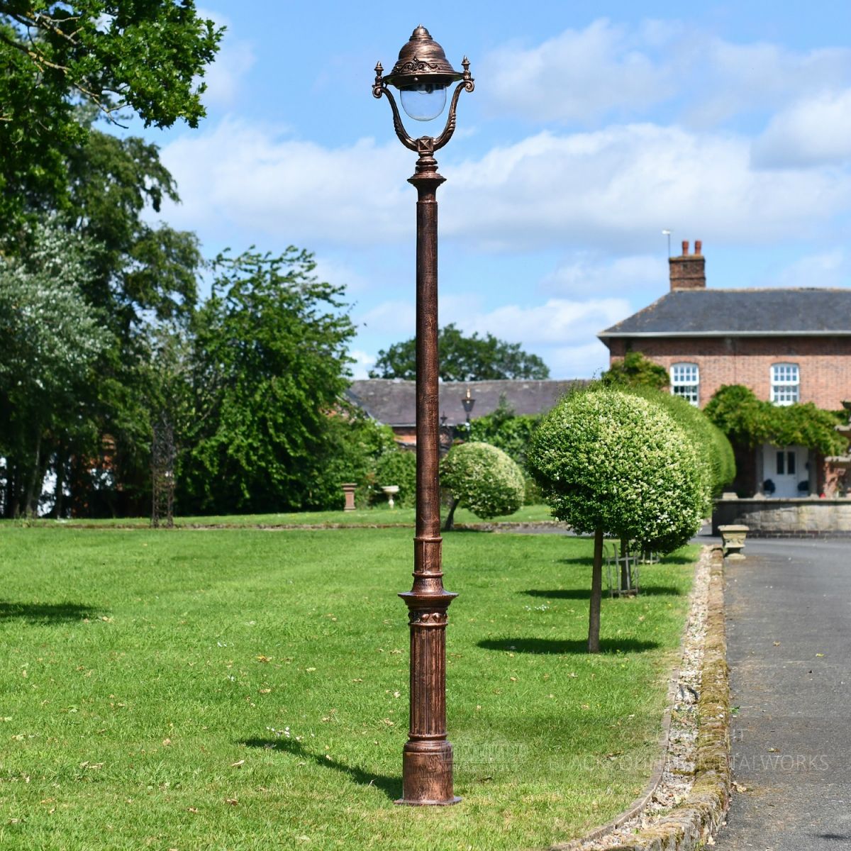 Antique Copper Finish Opulent Cast Iron Lamp Post Infront of Period Proprty