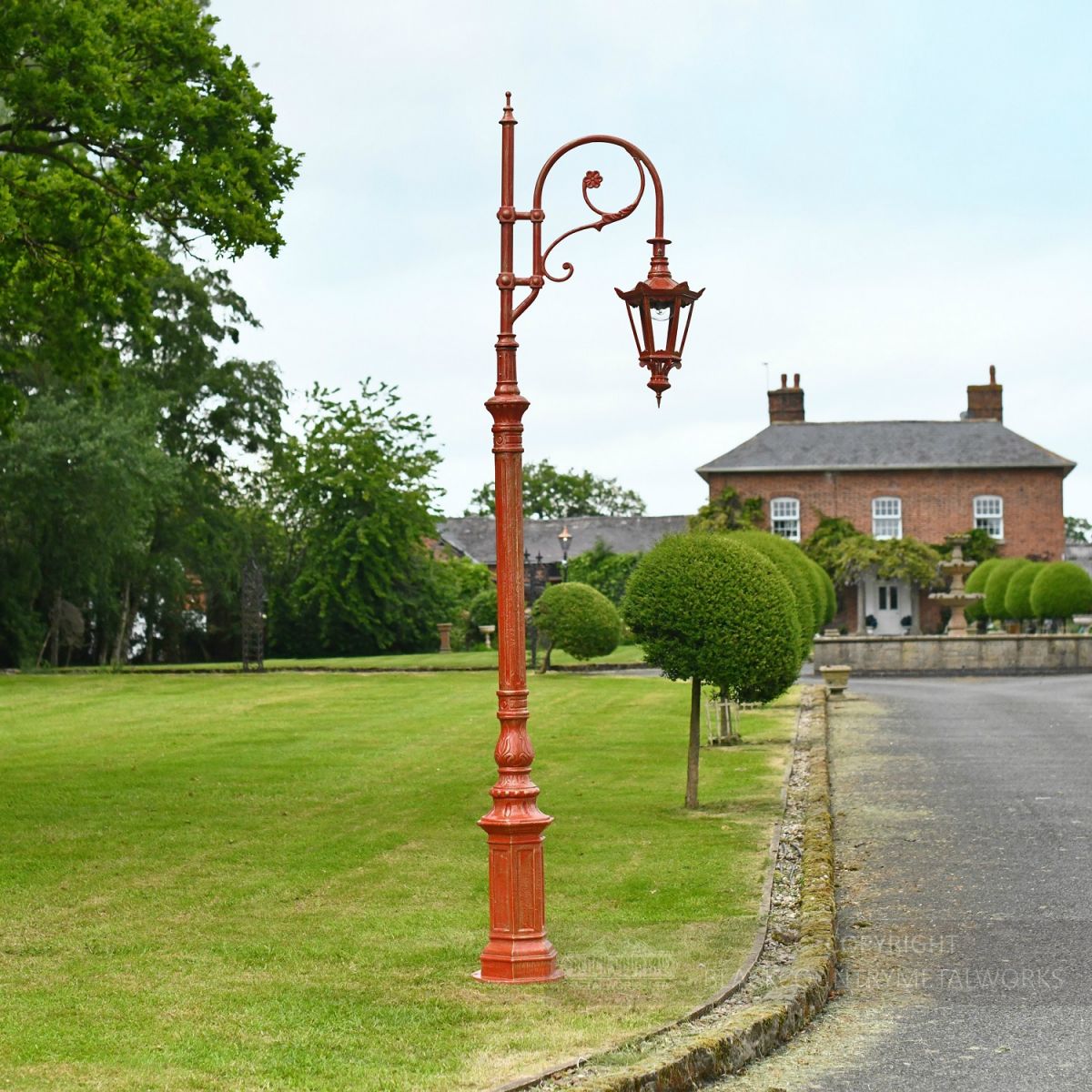 Antique Red Ornate Lamp Post in driveway of period property