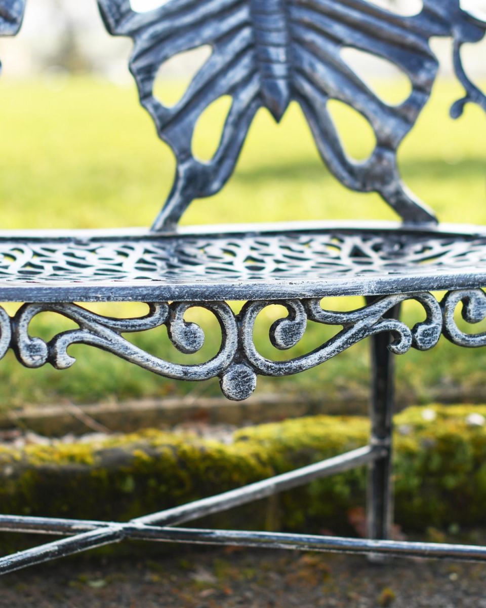 Close Up Of Antique Silver Butterfly Design Two Seater Bench Scrollwork