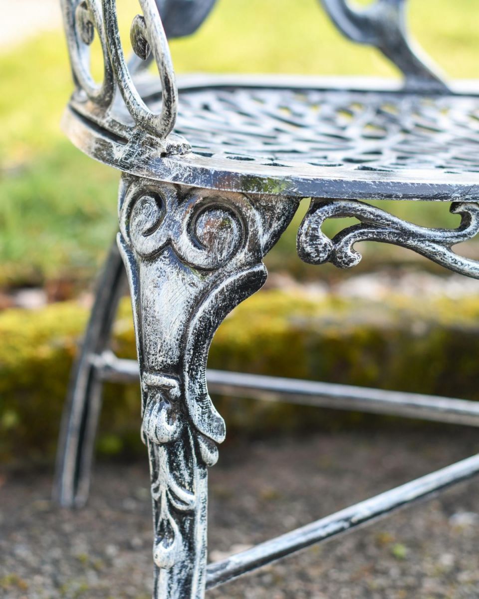 Close Up Of Antique Silver Butterfly Design Two Seater Bench Leg Detailing