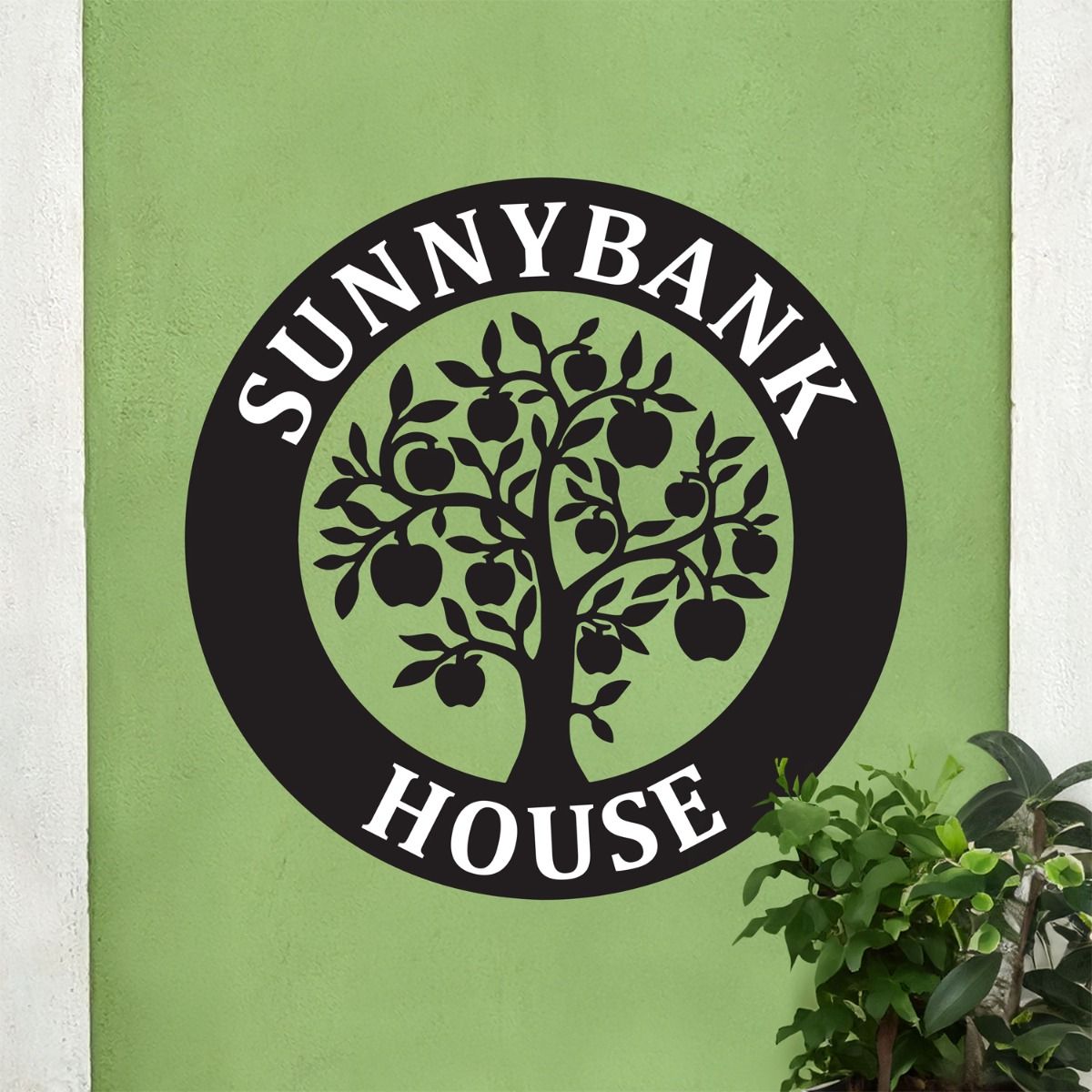 Circular House Name Sign on Green Wall 