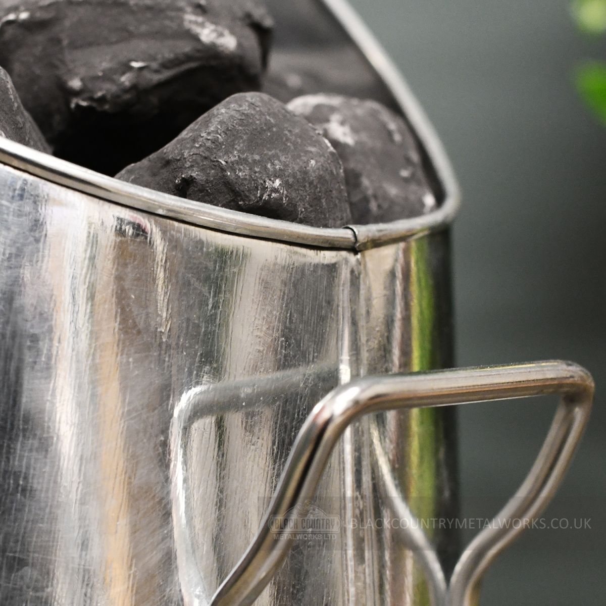 Detailed image of support handle on fireside coal Hod