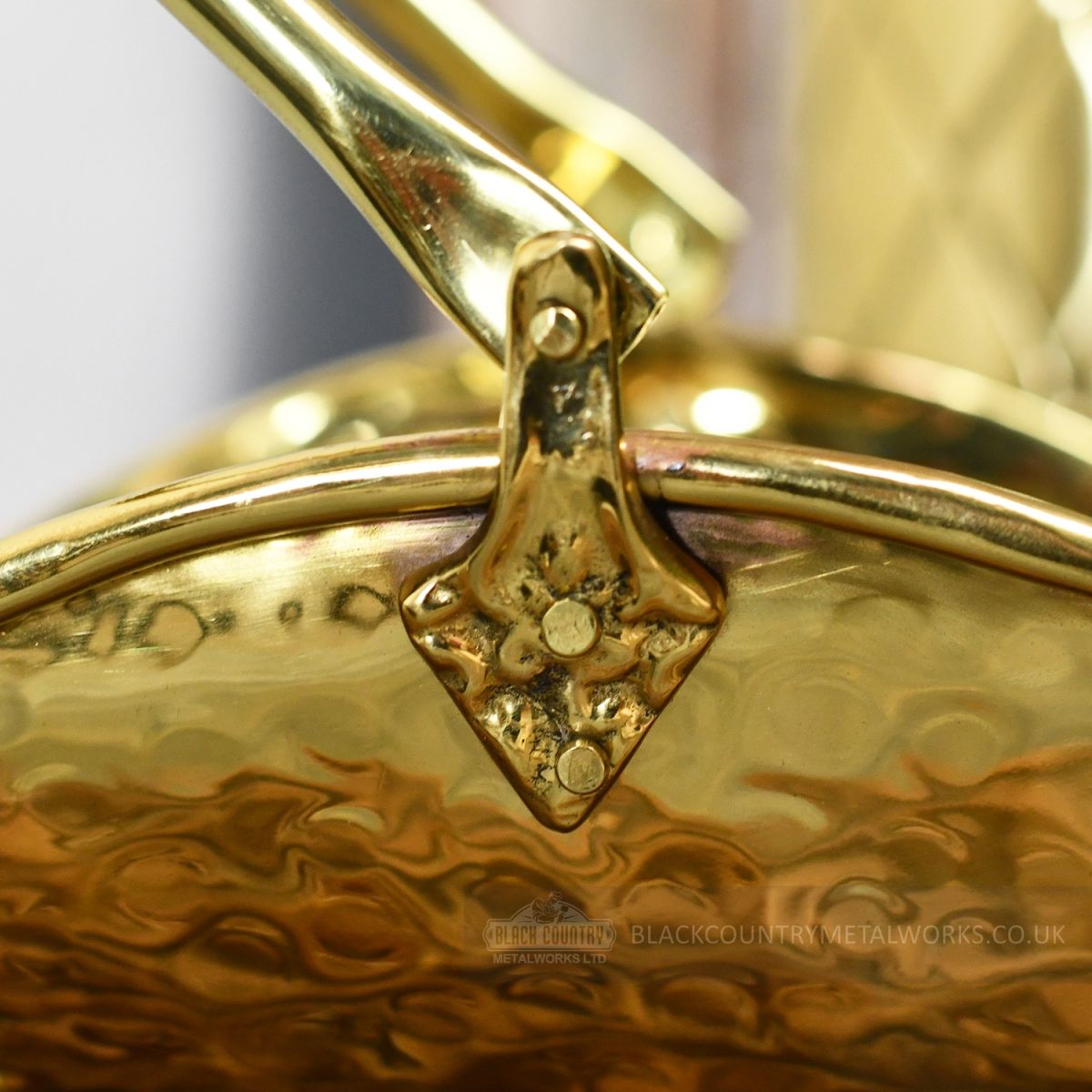 Detailed image of ornate clasp on fireside match holder handle