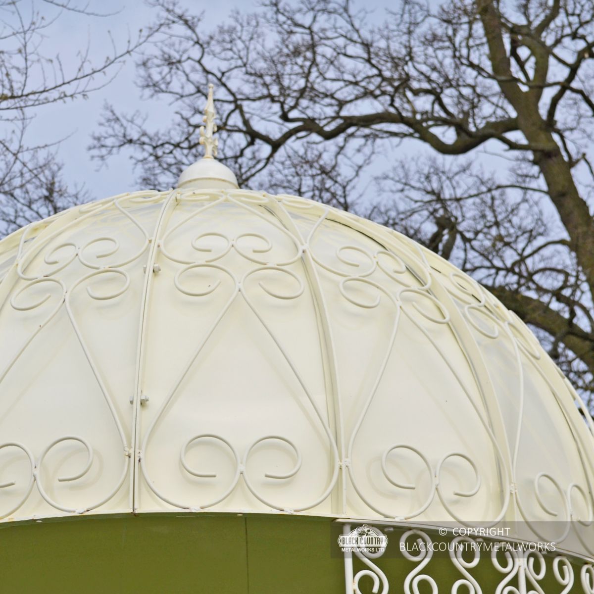 Solid roof with ornate scrolling pattern on garden pavilion