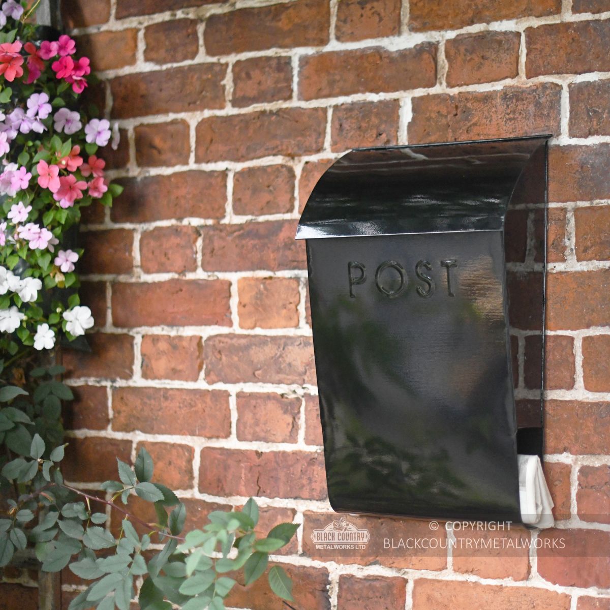 Newspaper post box mounted on wall