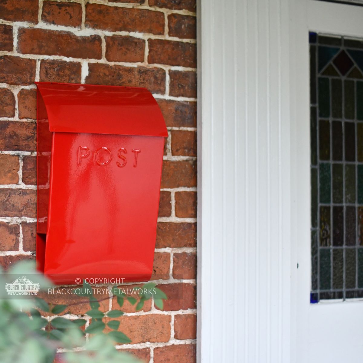 Modern post box mounted outside front door