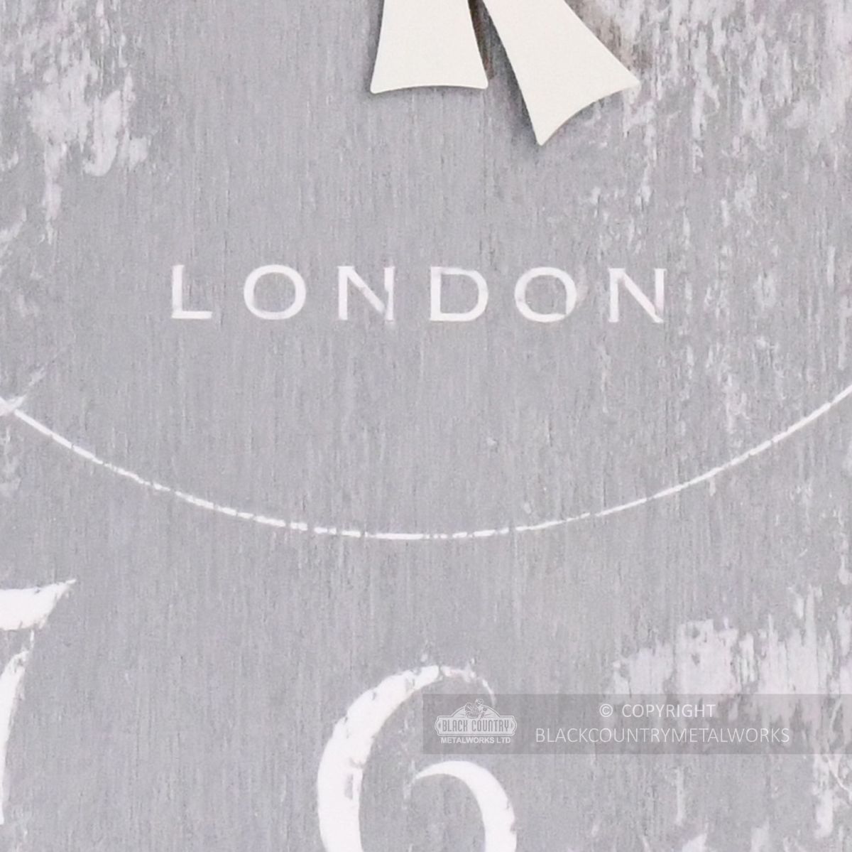 Close up of printed text "London" on wall clock
