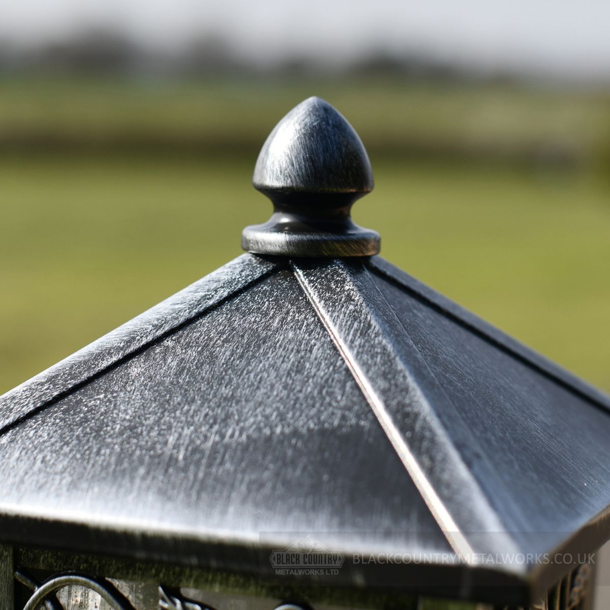 Close up of black & silver finish on finial
