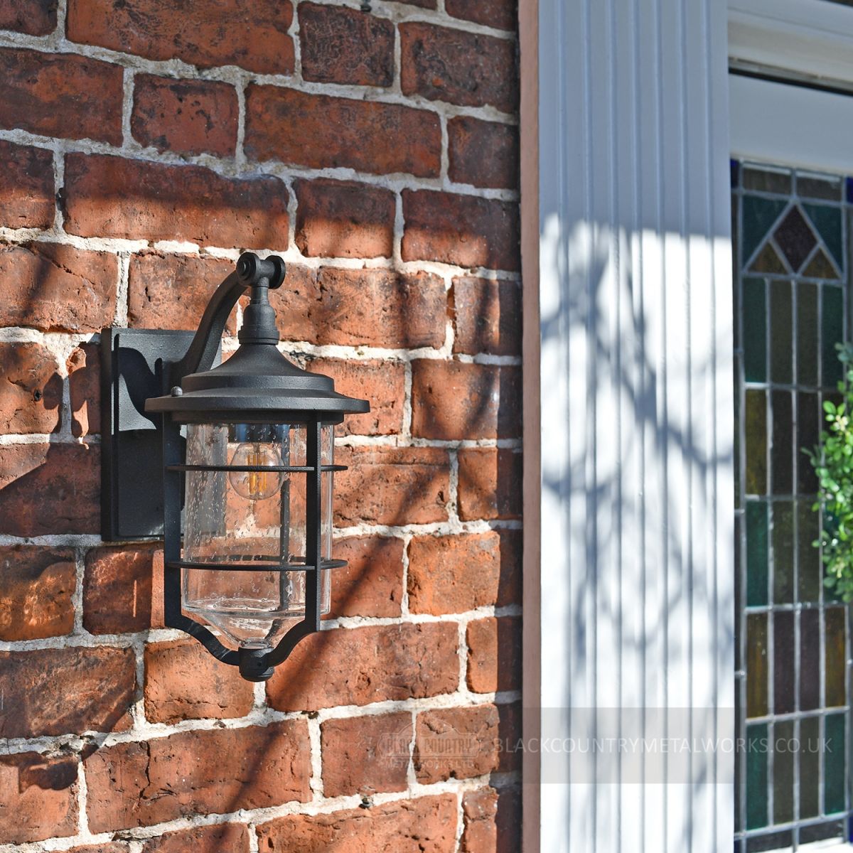 Beautiful nautical garden lantern on brick wall