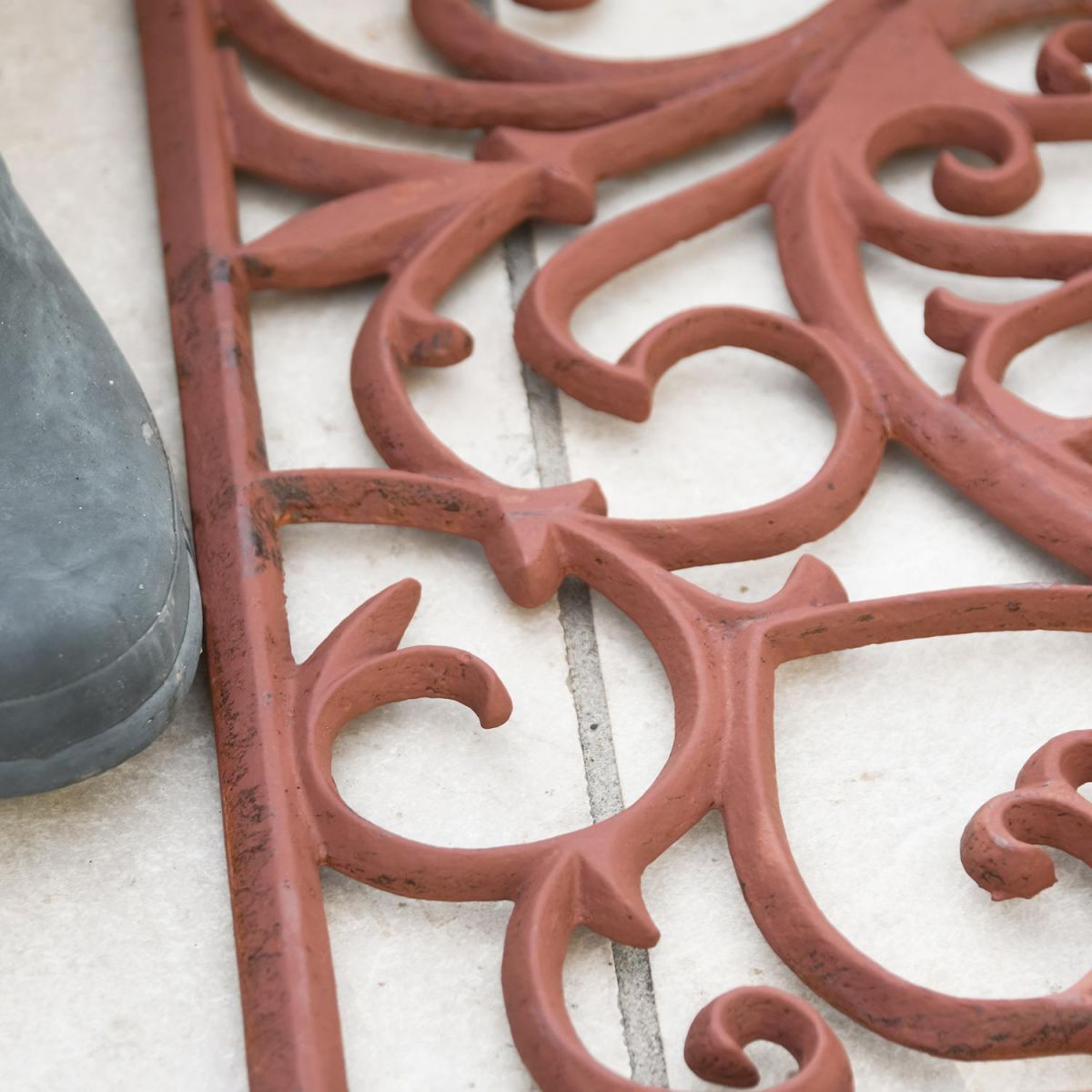 Close-up of the Ornate Scroll Pattern on the Doormat